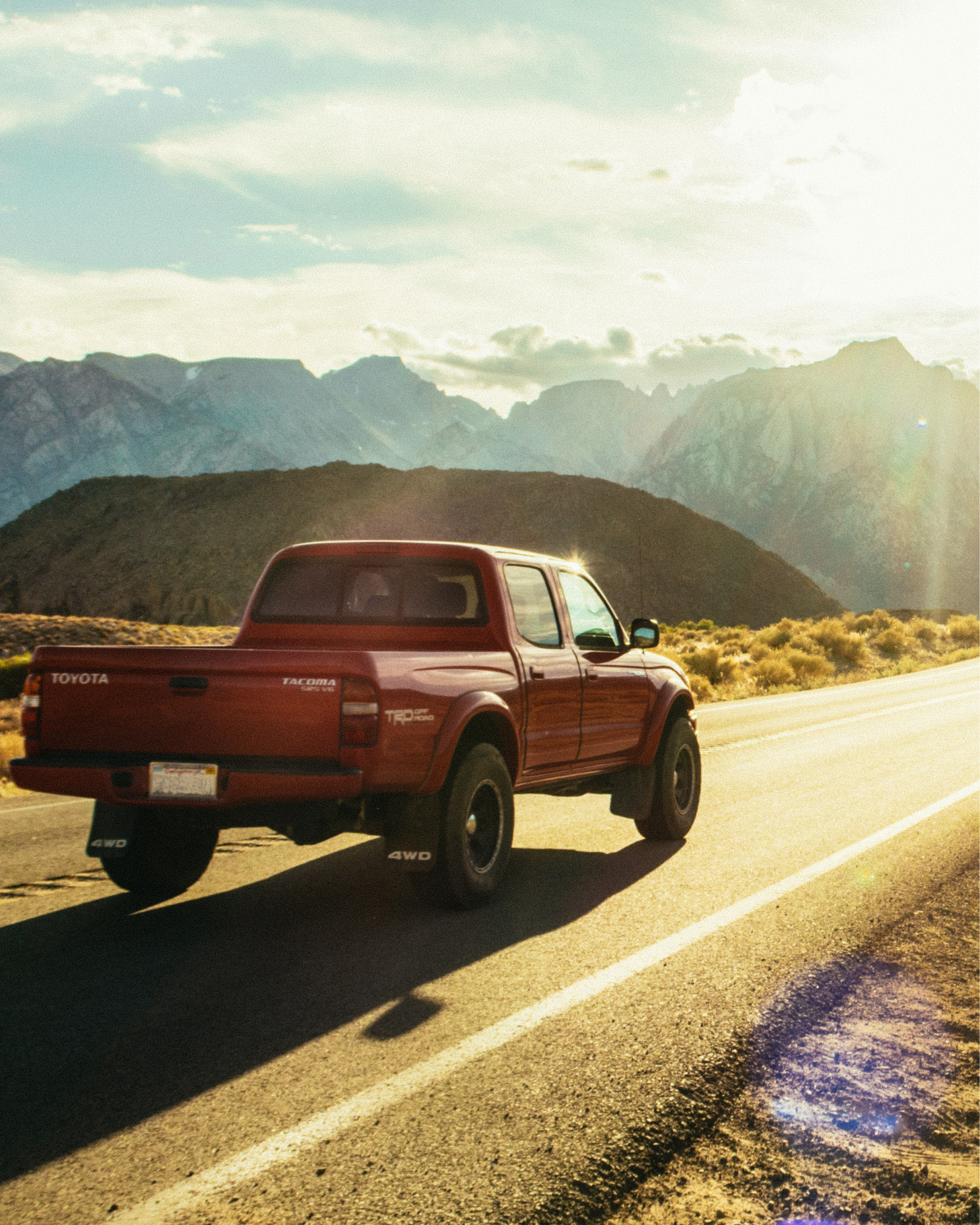 Pickup truck traveling on a mountain road, representing light vehicle control cable and actuation applications